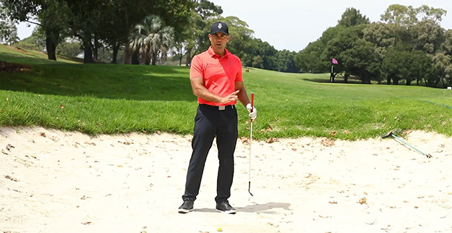 golf using the bottom of the club in a bunker demonstration