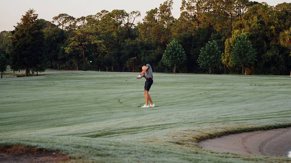 golfer taking shot on course