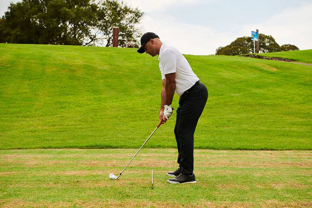 golfer using alignment sticks to practice
