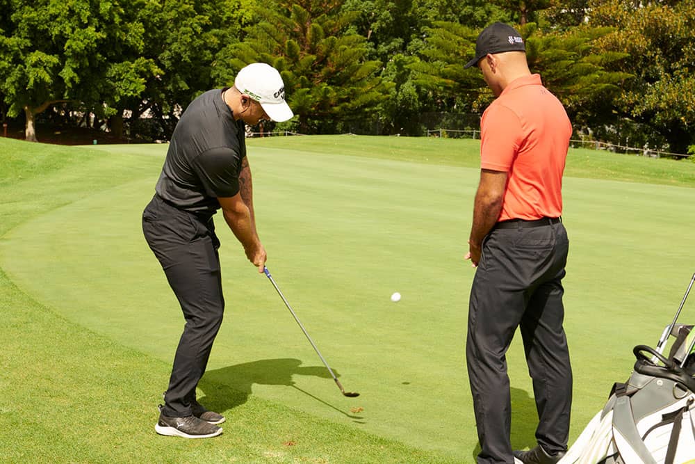 golfer in bunker using sand wedge